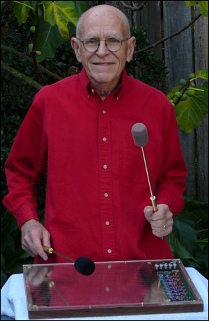 Max Mathews playing Radio Baton in garden